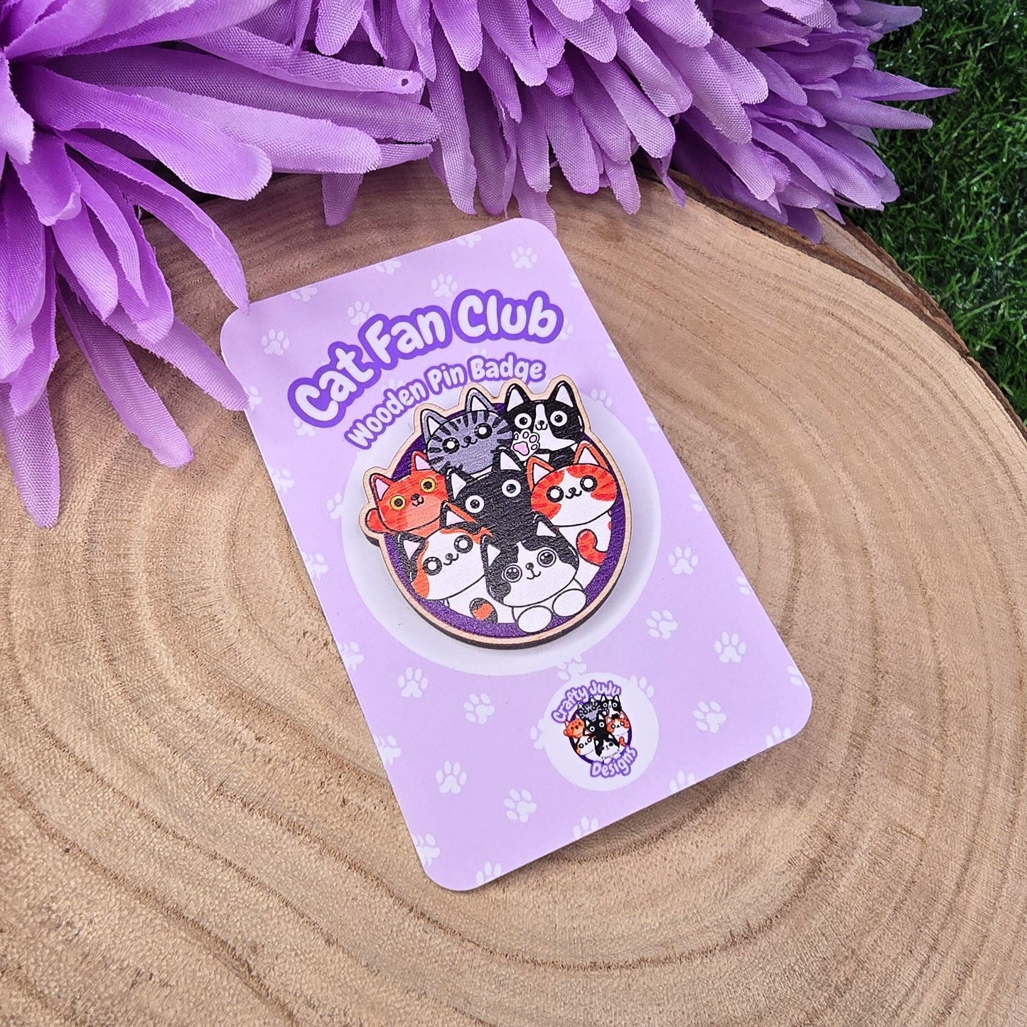 Cat Fan Club badge on a purple card with flowers in the background