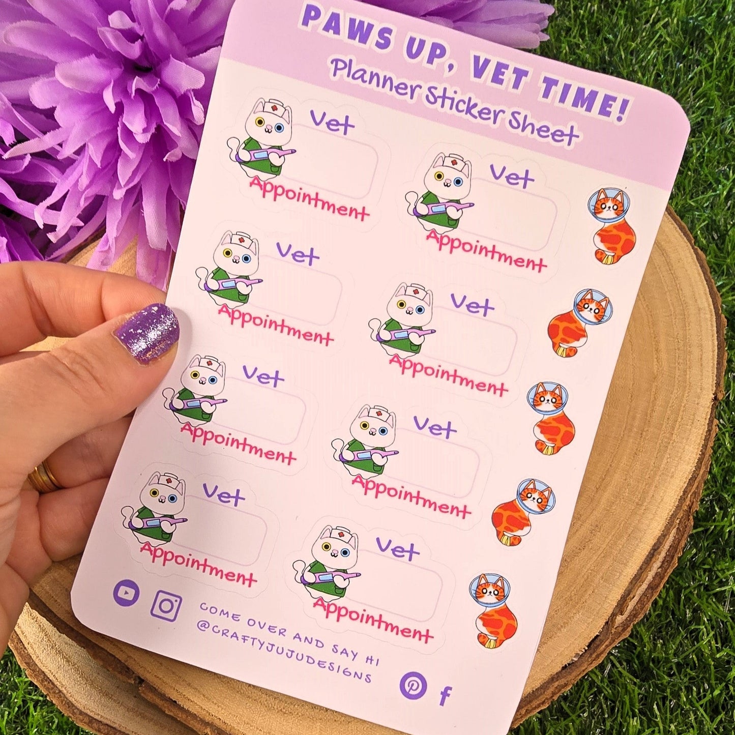 Sheet of planner stickers with 'Vet Appointment' design held over a purple flower and grass background.