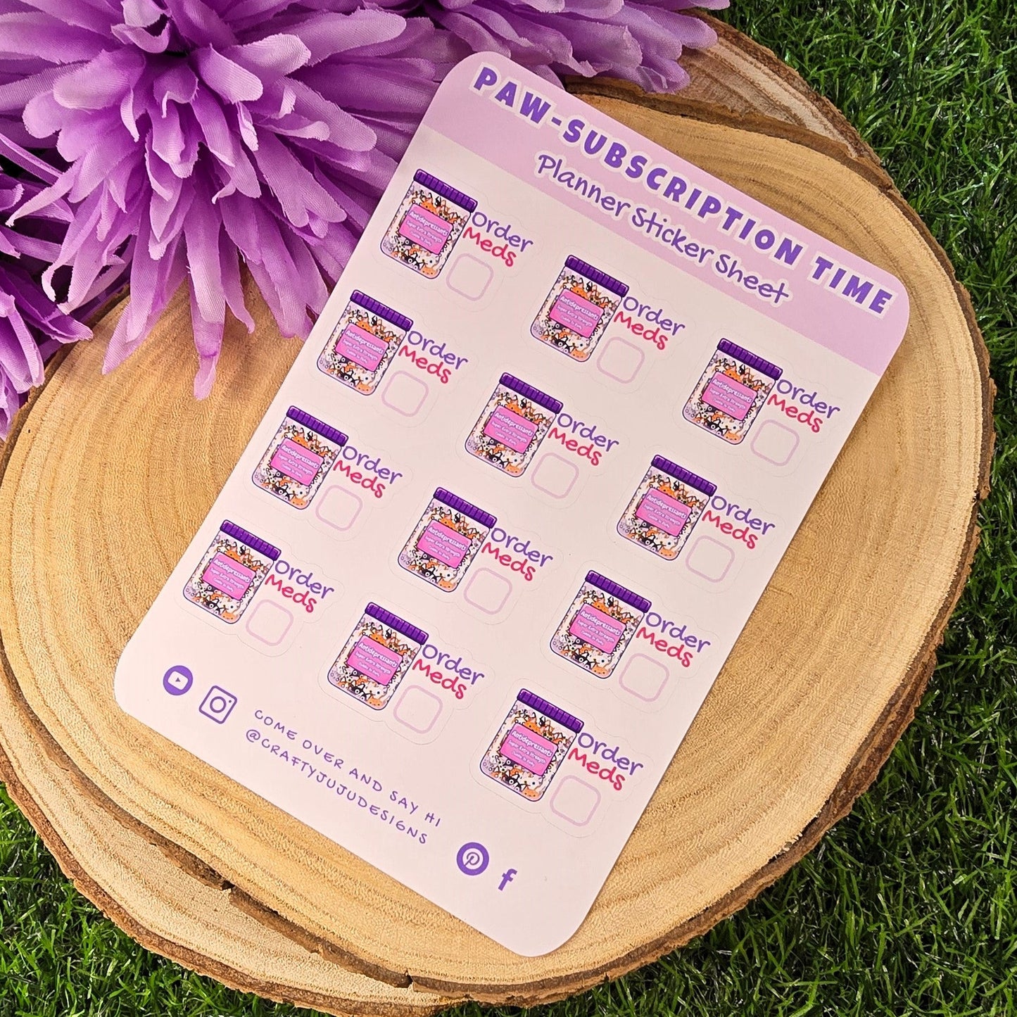 planner stickers on a wooden stand with purple flowers in the background