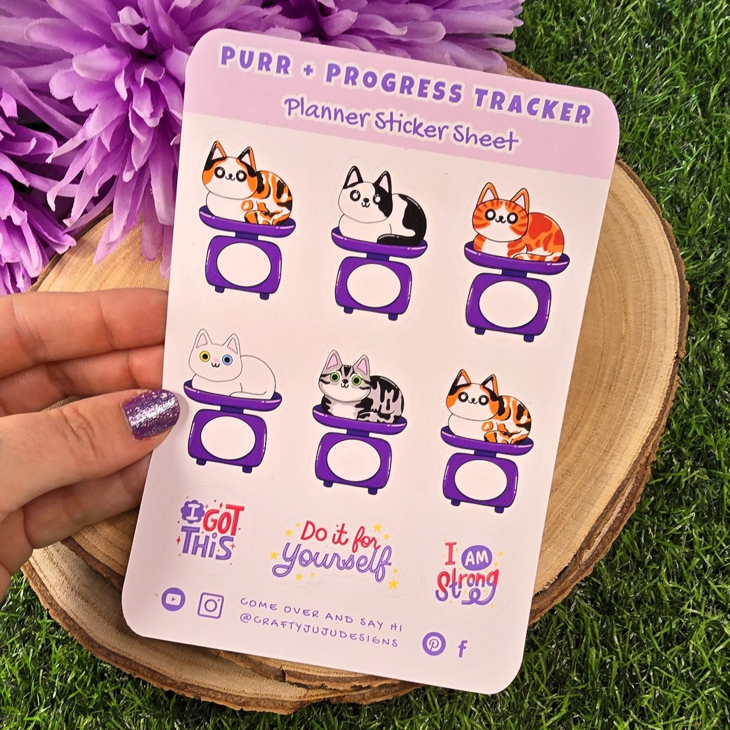 Sheet of planner stickers with cat designs on a grass background