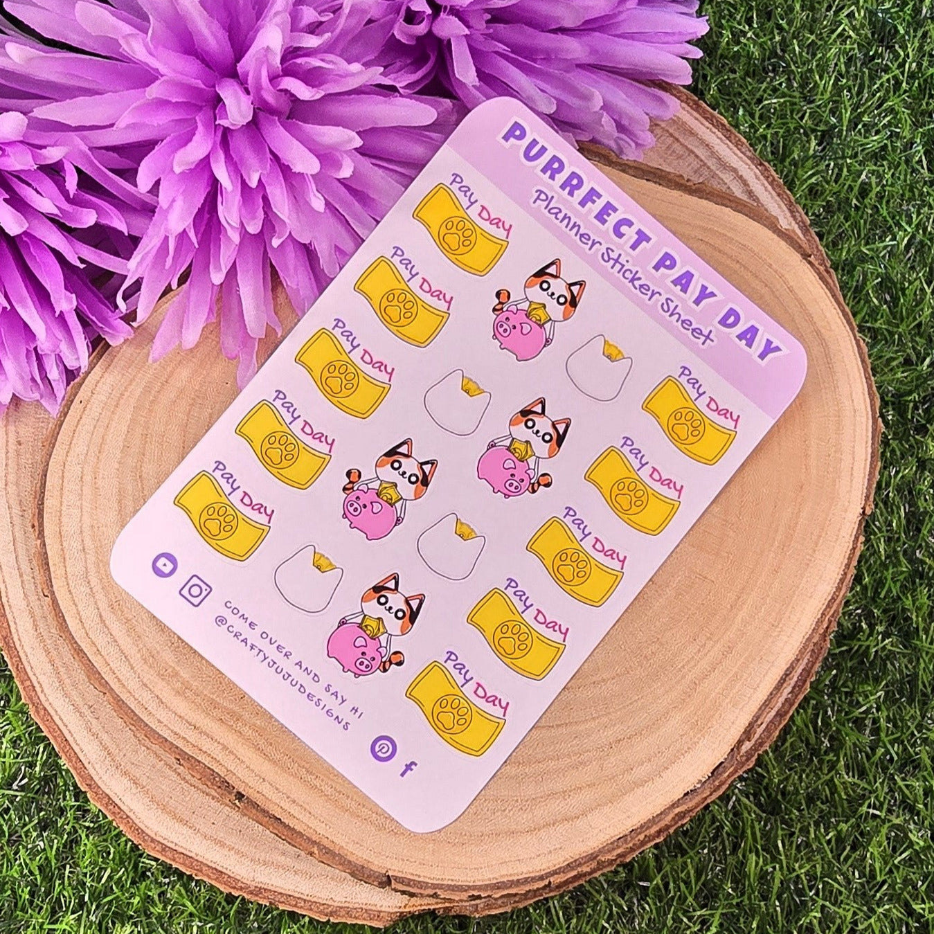 Sticker sheet titled 'Purrfect Pay Day' on a wooden surface with purple flowers.