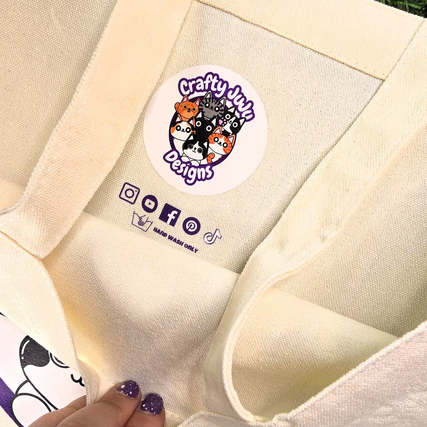 tote with a logo and text on a grassy background