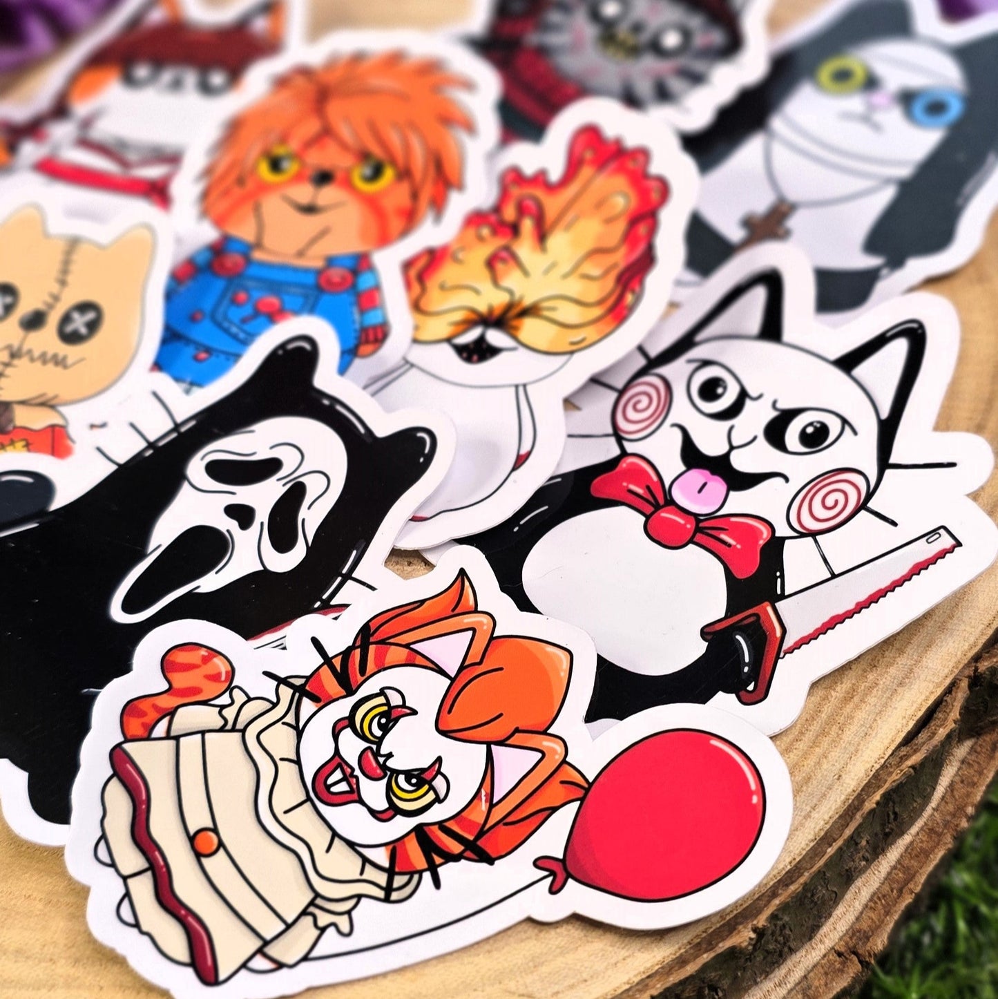 Collection of cartoon stickers on a wooden surface with purple flowers in the background