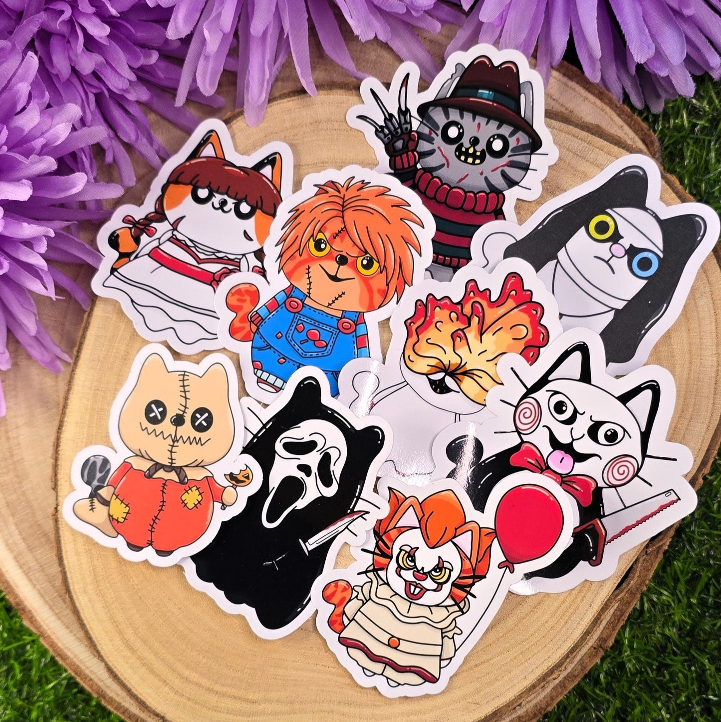 Set of colorful cartoon-style stickers on a wooden surface with purple flowers in the background