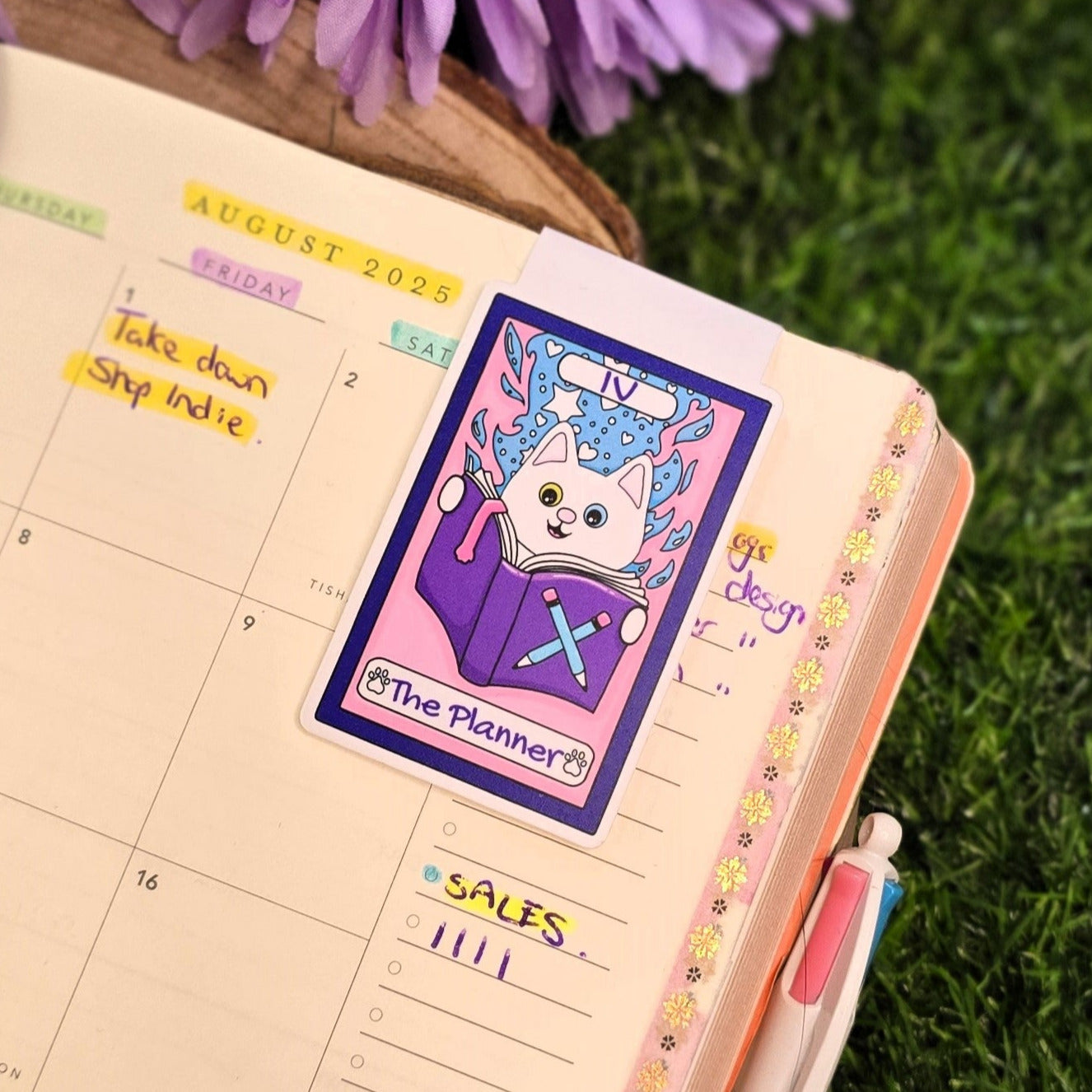 Planner with a sticker on a grassy background