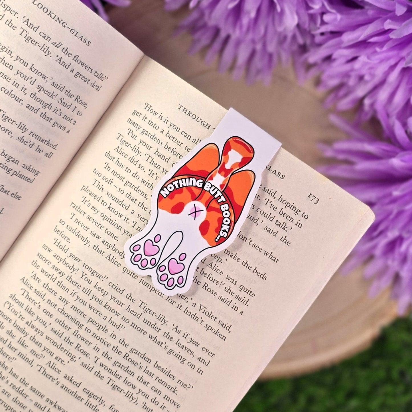 Book with a cat butt
bookmark and purple flowers in the background