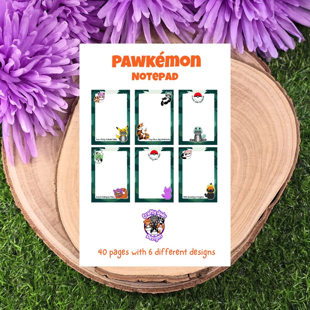 Pawkémon Notepad on a wooden surface with purple flowers