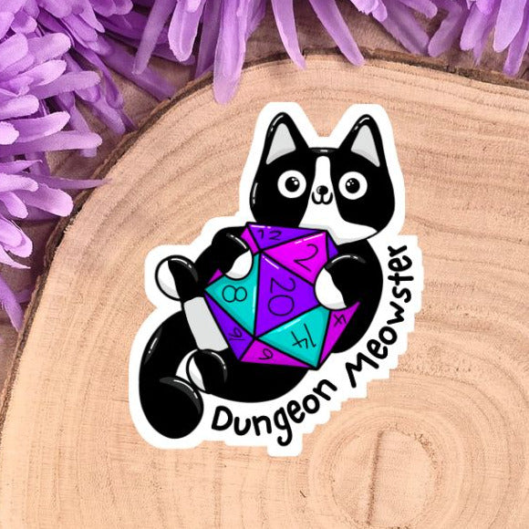 Sticker of a black cat holding onto a D&D dice. with a purple and blue gem on a wooden log with purple flowers. D&D and tabletop gamers
