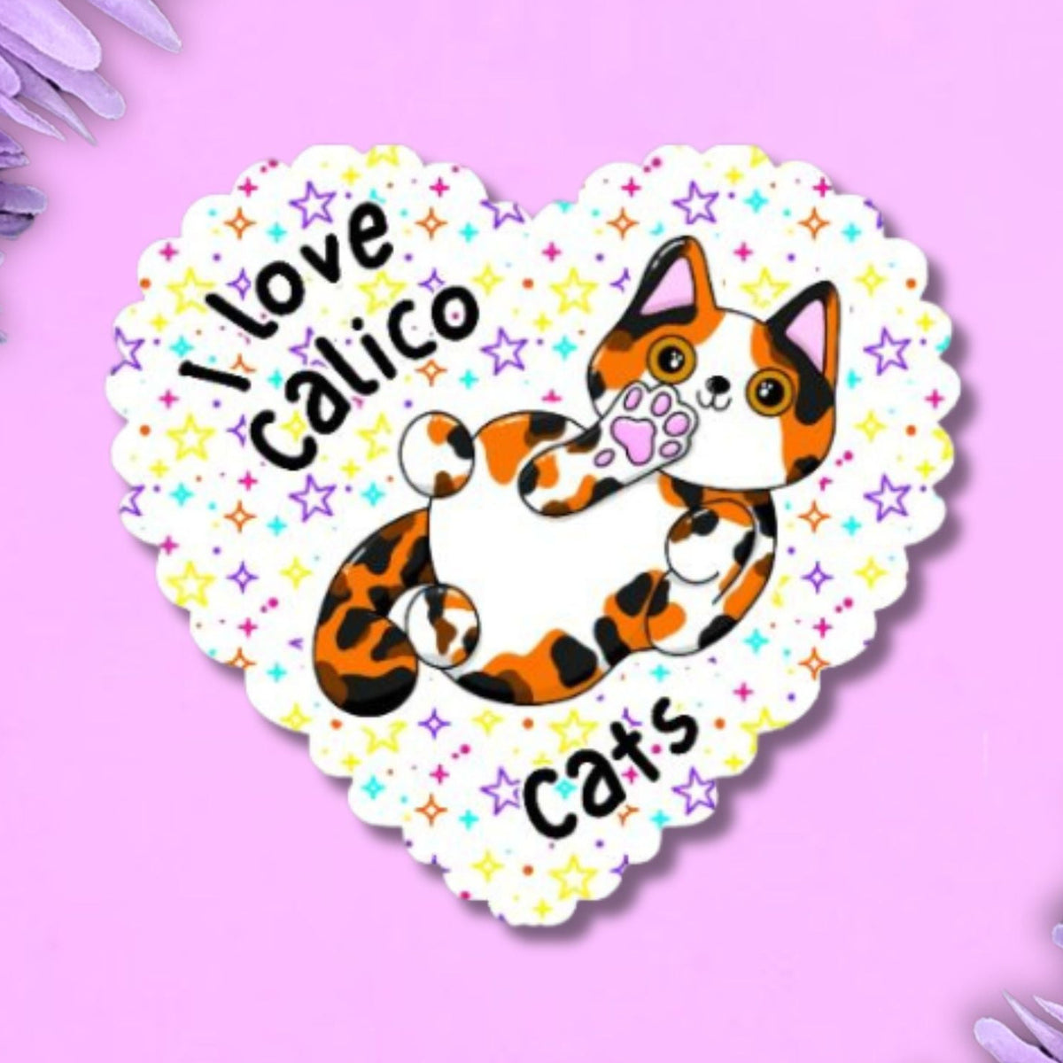 A heart-shaped sticker featuring a cartoon calico cat and the text 'I love calico cats' on a pink background with purple flowers in the corners.