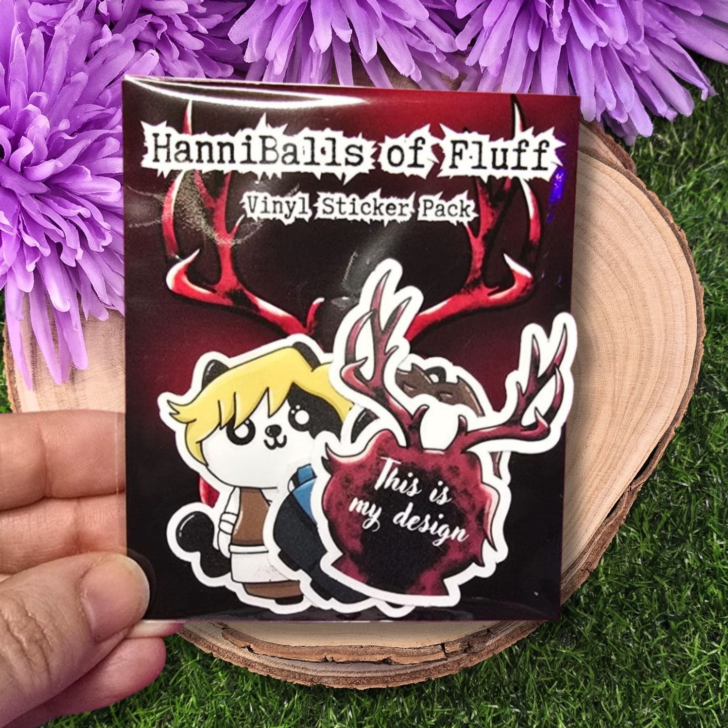 HanniBalls of Fluff vinyl sticker pack with a cartoon character and text on a purple flower background
