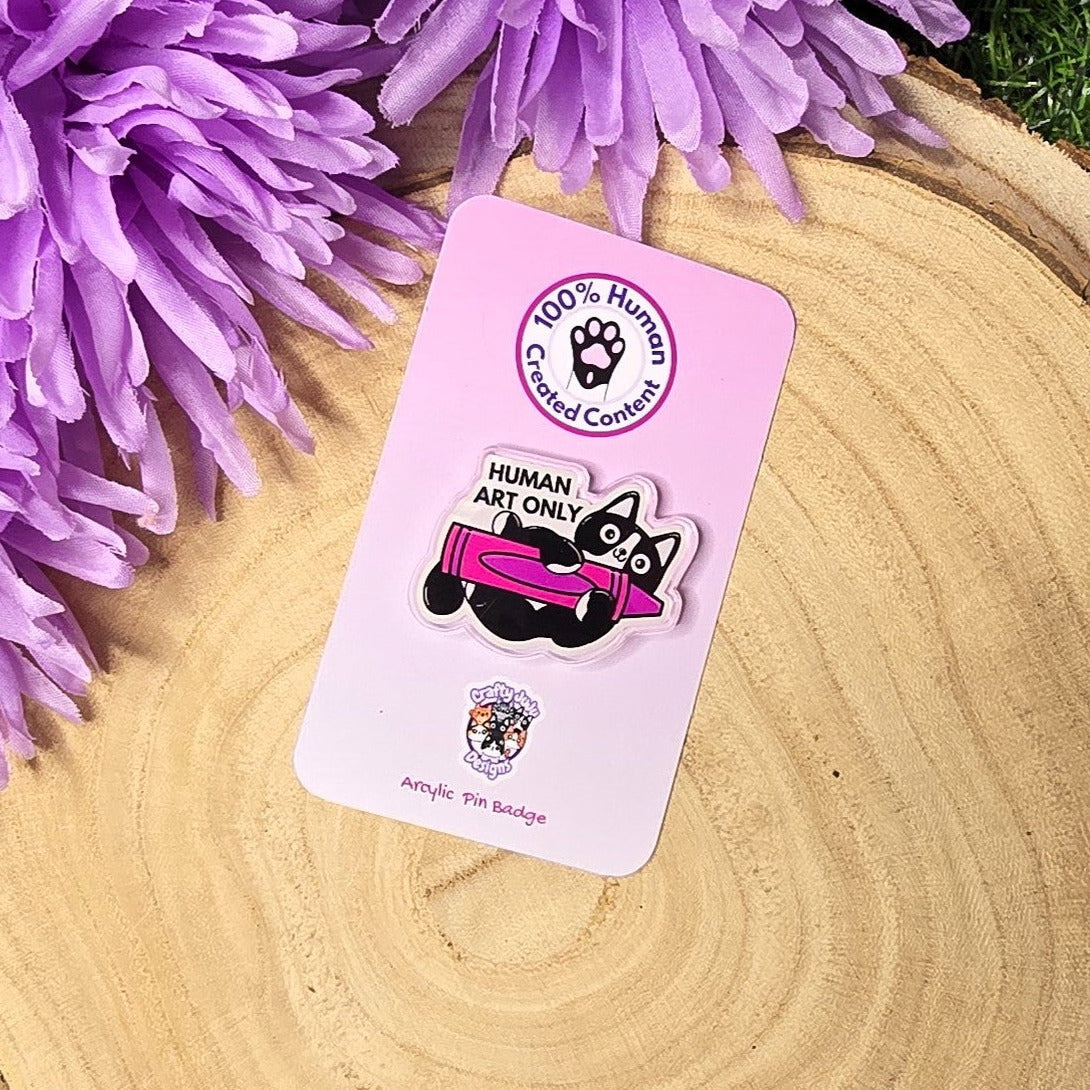 Human art only acrylic pin badge showing black and white cat holding pink crayon, artist humour accessory 4cm UK
