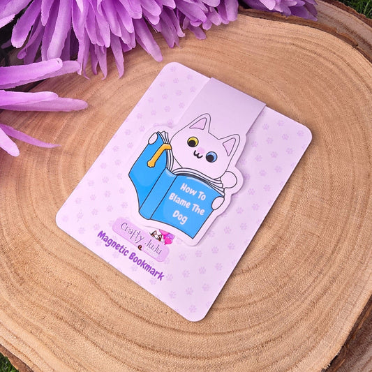 Card with a cartoon cat design on a wooden surface with purple flowers
