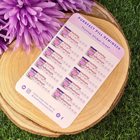 pill reminder planner sticker sheet on a wooden surface with grass background