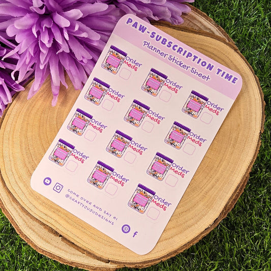 planner stickers on a wooden stand with purple flowers in the background