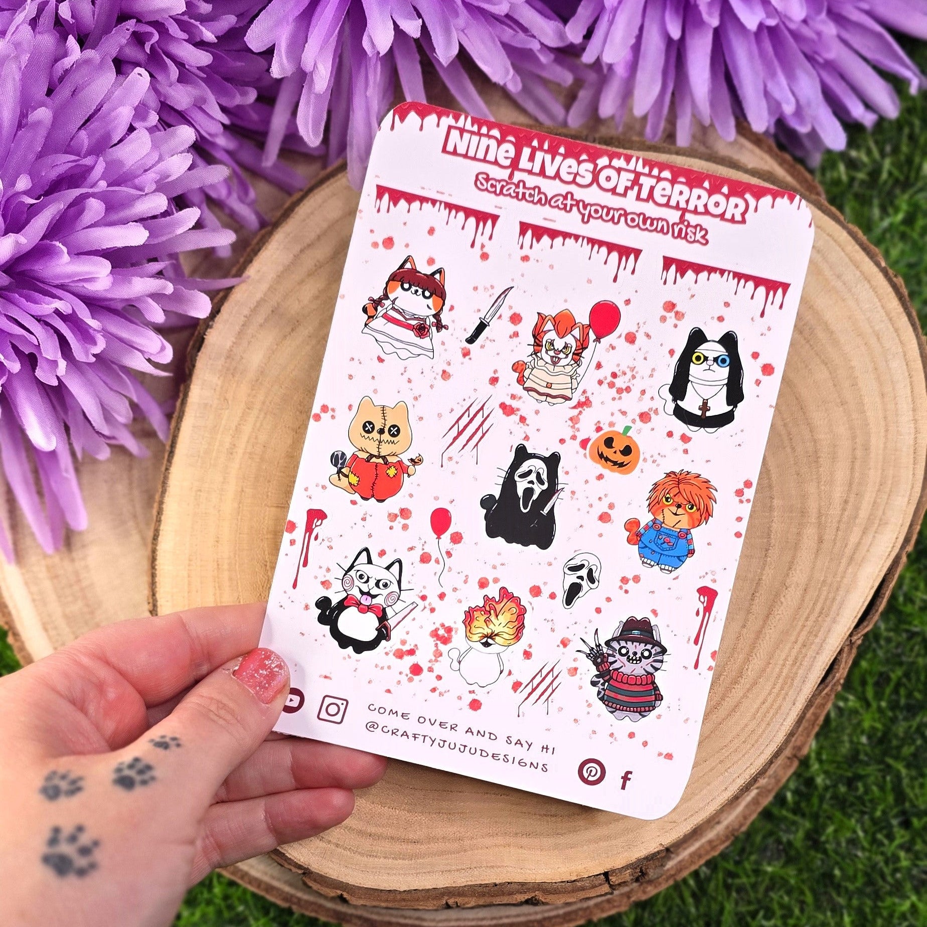 Sheet of stickers held by a hand with purple flowers in the background