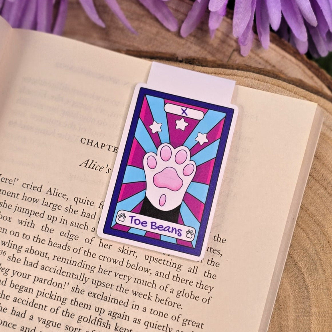 Colorful bookmark with paw design on an open book
