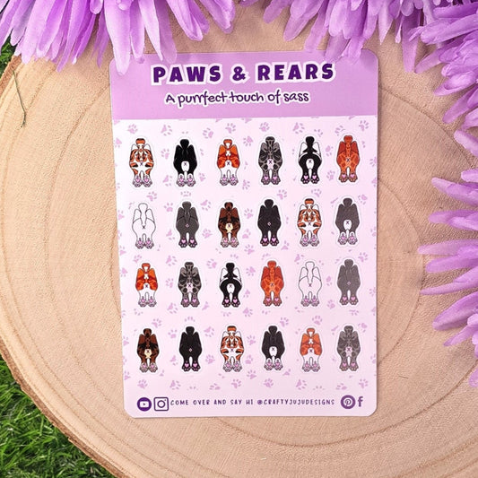 Sheet of 'Paws & Rears' stickers on a wooden surface with purple flowers.