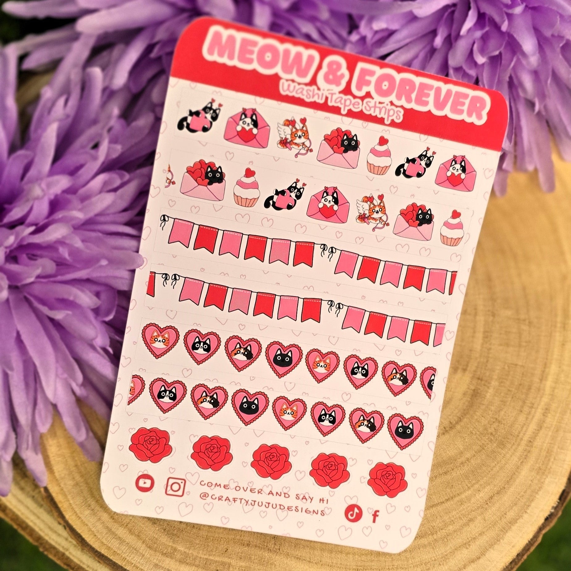 Sticker sheet featuring cats and hearts on a wooden surface with purple flowers in the background