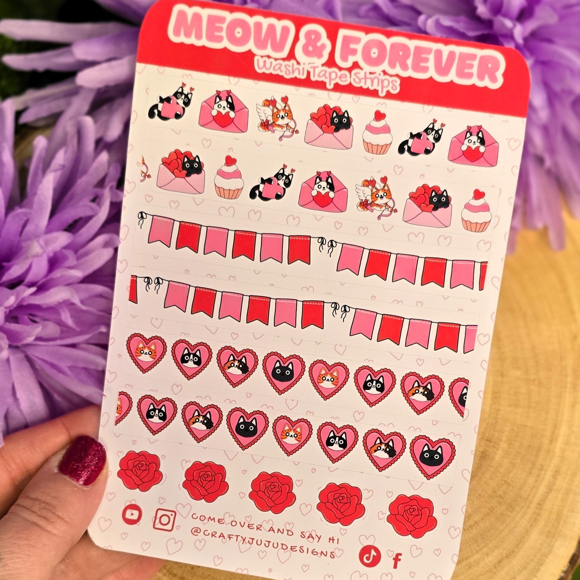 Sheet of stickers with cat characters and text 'Meow & Forever' held over purple flowers.