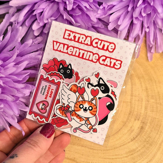 cat sticker pack held by a hand in front of purple flowers