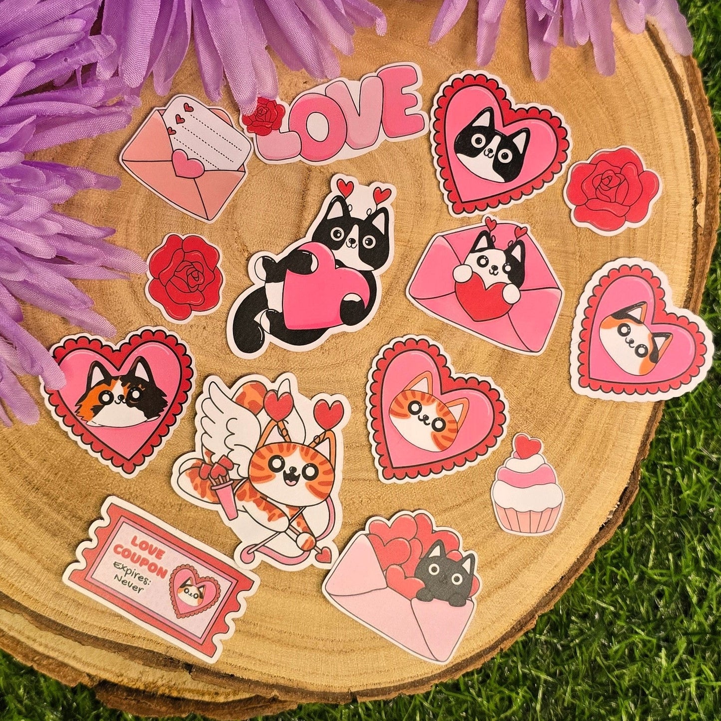 Set of stickers with cartoon characters on a wooden board surrounded by purple flowers on grass.