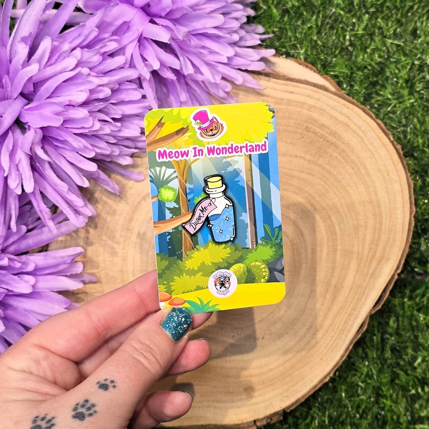 Drink Me bottle enamel pin with blue glitter liquid