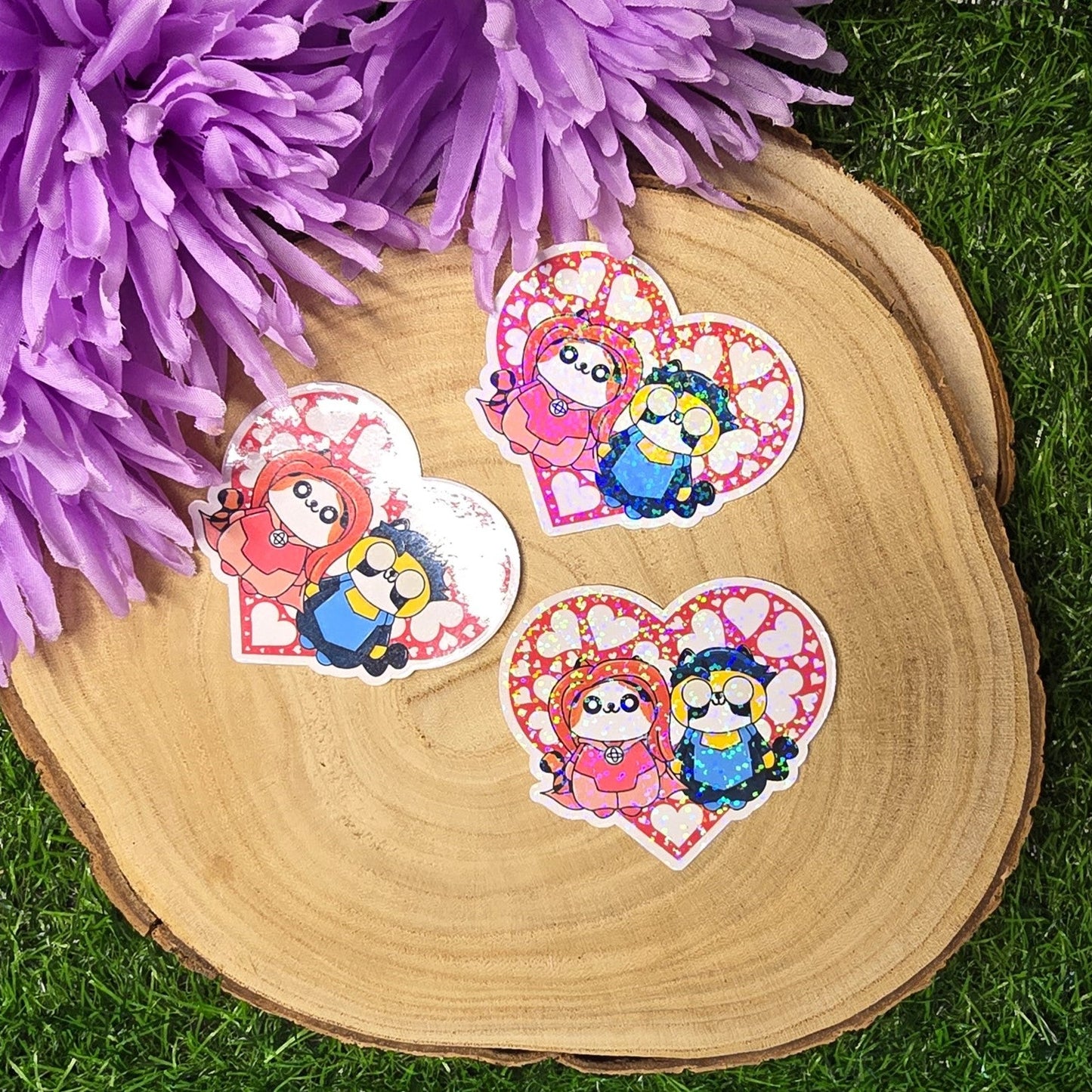 Holographic superhero power couple cat vinyl sticker with heart surround, comic inspired die cut waterproof handmade sticker 6cm UK