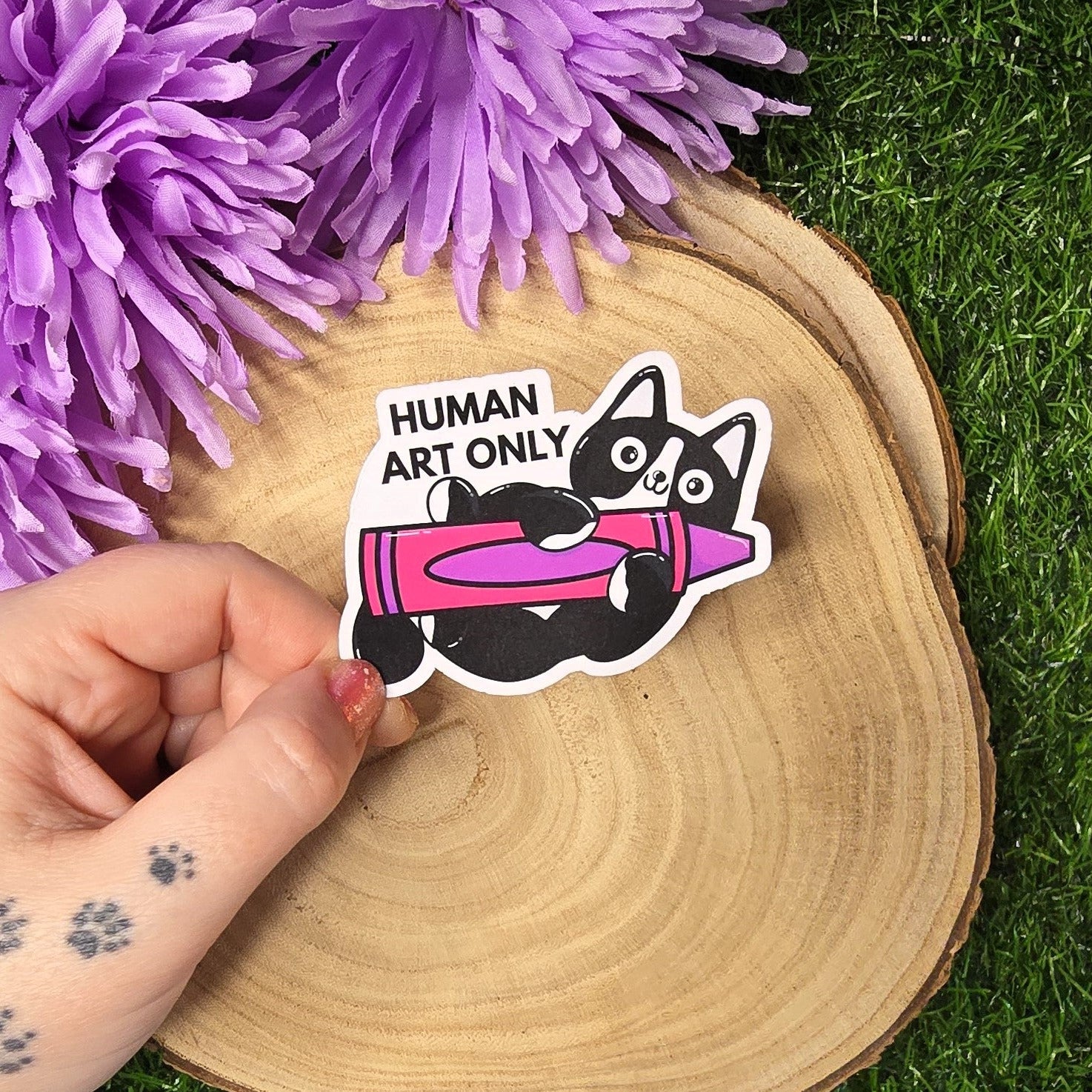 Human art only cat matte vinyl sticker showing black and white cat holding pink crayon, die cut waterproof handmade sticker 8cm UK