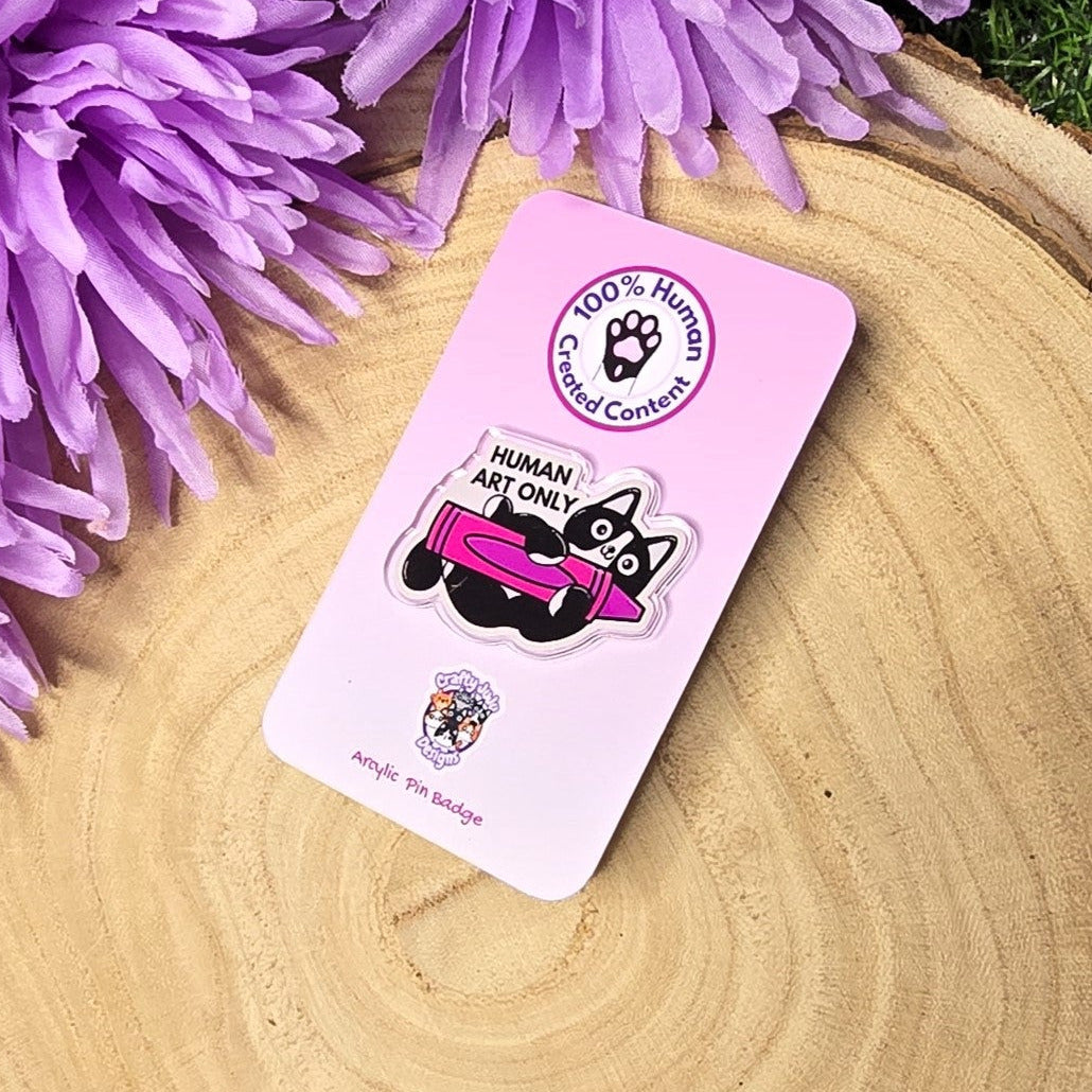 Human art only acrylic pin badge showing black and white cat holding pink crayon, artist humour accessory 4cm UK