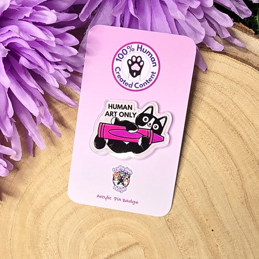 Human art only acrylic pin badge showing black and white cat holding pink crayon, artist humour accessory 4cm UK