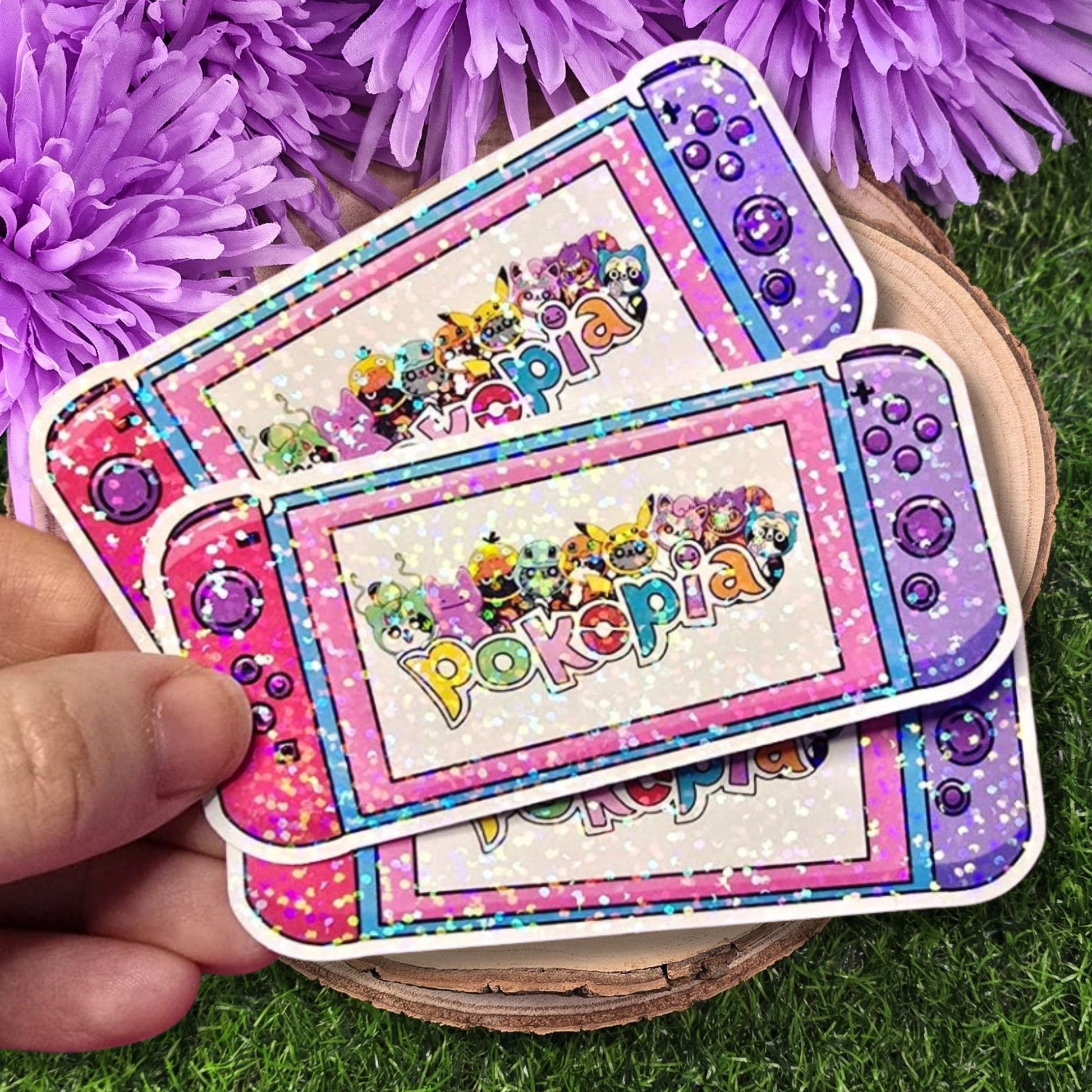 3 Pokopia-themed cards held by a hand with purple flowers in the background