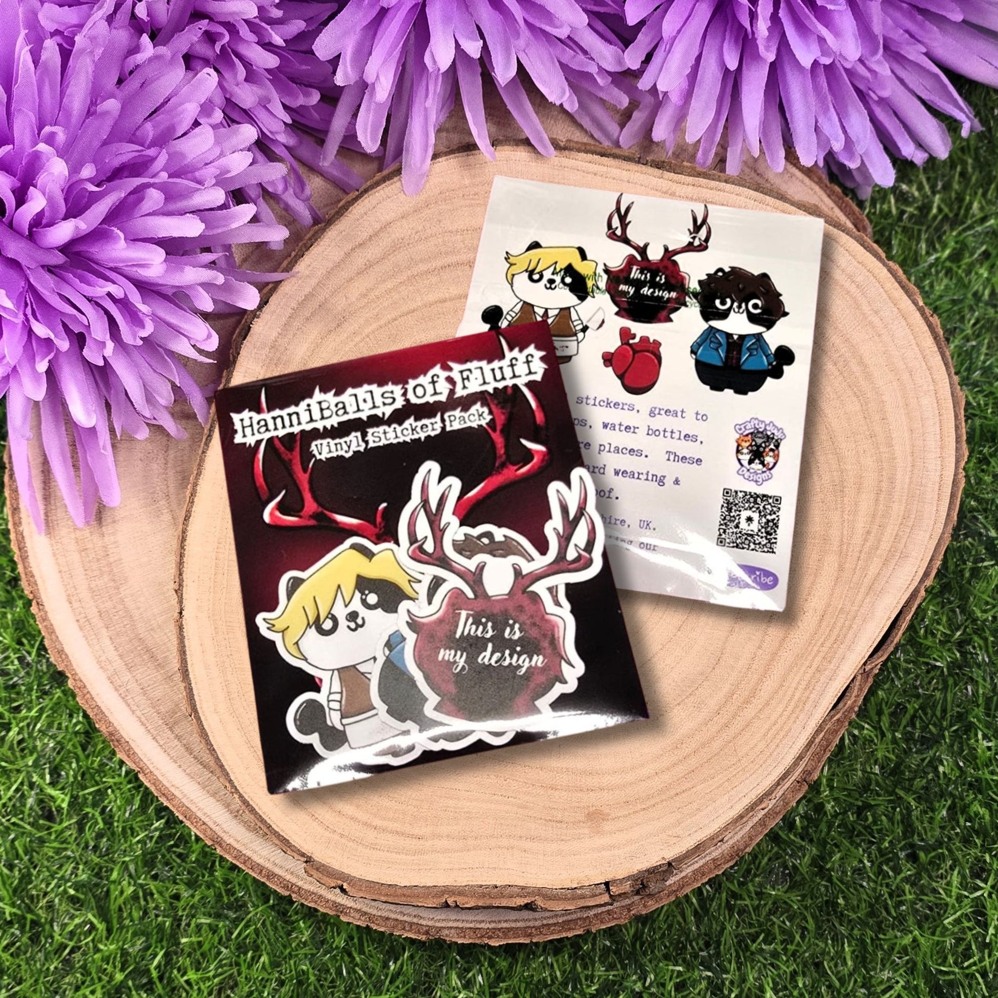 Sticker designs on a wooden surface with purple flowers in the background