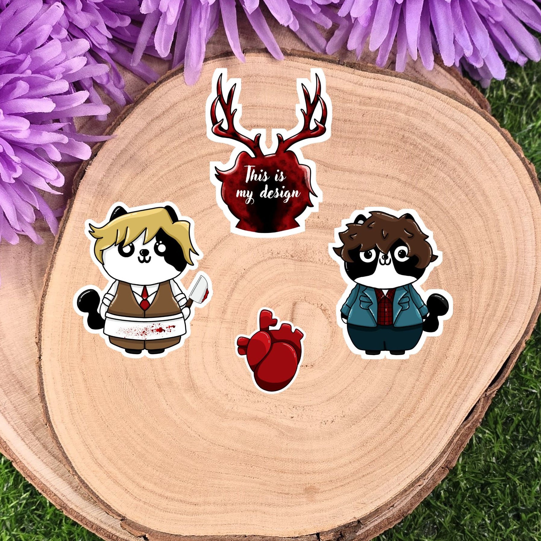 Four hannibel cartoon character stickers on a wooden disc with purple flowers in the background