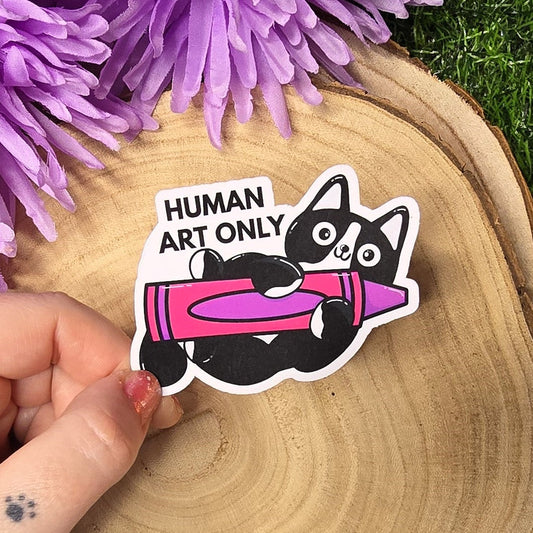 Human art only cat matte vinyl sticker showing black and white cat holding pink crayon, die cut waterproof handmade sticker 8cm UK