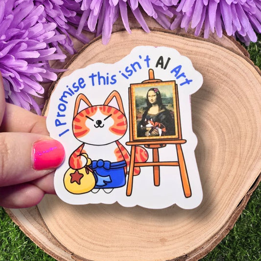 Sticker with cartoon cat and Mona Lisa parody on a wooden surface with purple flowers in the background. I Promise This Isn't AI Art