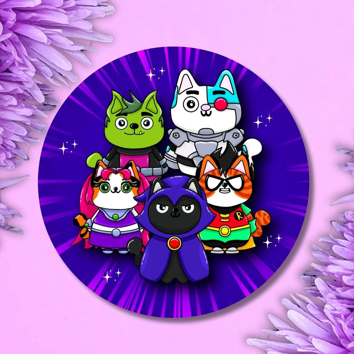 A circular sticker or button featuring five cartoon cat superheroes on a purple starburst background, displayed on a pink background with purple flowers in the corners.