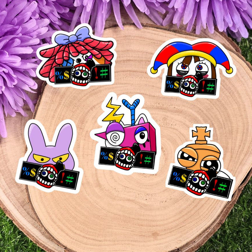 Five colorful stickers with cartoon designs on a wooden surface with purple flowers in the background.