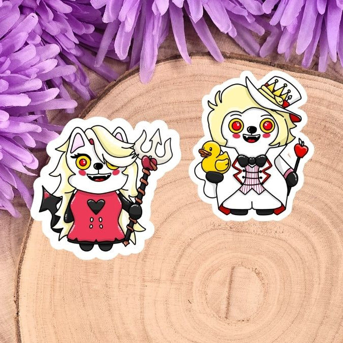 Two cartoon character stickers on a wooden disc with purple flowers in the background
