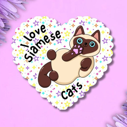 A heart-shaped sticker featuring a Siamese cat with the text 'I love Siamese cats' on a light purple background with purple flowers in the corners.