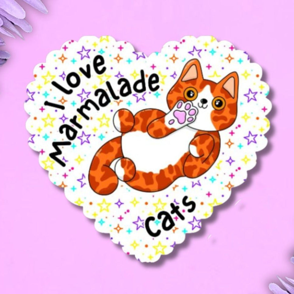 I love marmalade holographic heart shaped sticker with a scalloped edge. The background is white with multi coloured stars. The cat is ginger and white, on its back showing off their belly