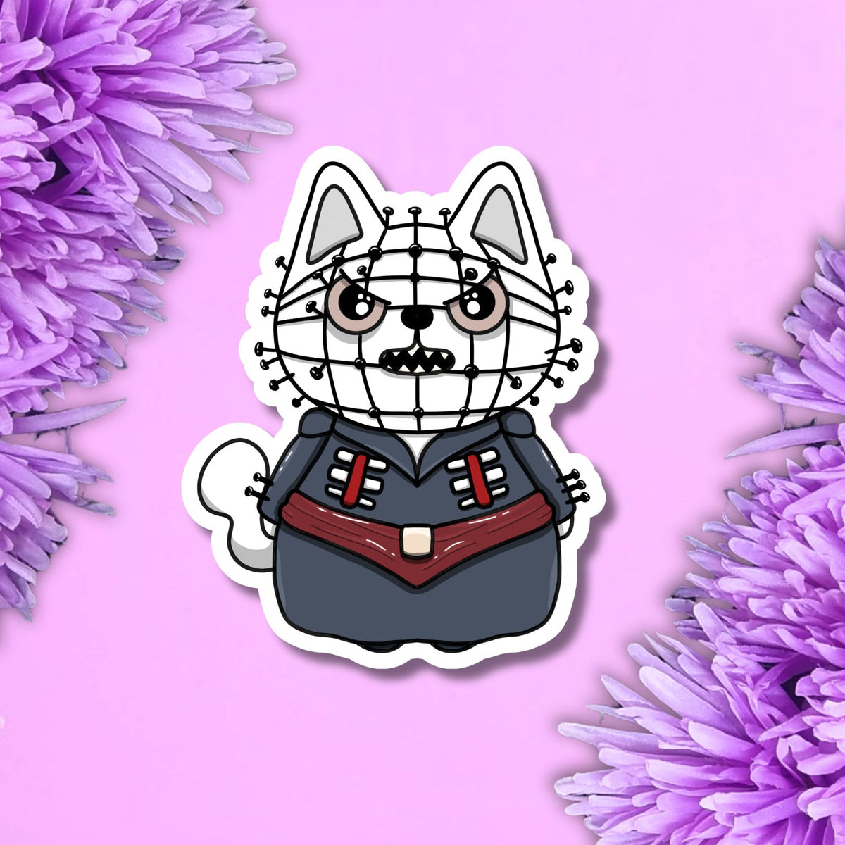 A die-cut sticker featuring a cartoon cat character dressed in a black and red uniform with a wire face mask, centered on a pink background with purple flowers at the corners.