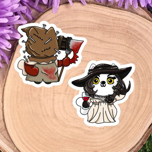 Two stickers of cartoon characters on a wooden surface with purple flowers in the background
